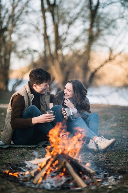 Couple sitting near campfire