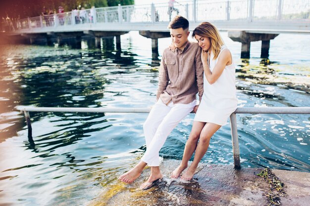 Couple sitting on pier