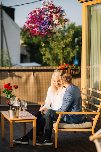 Free Photo couple sitting on rooftop enjoying the time together