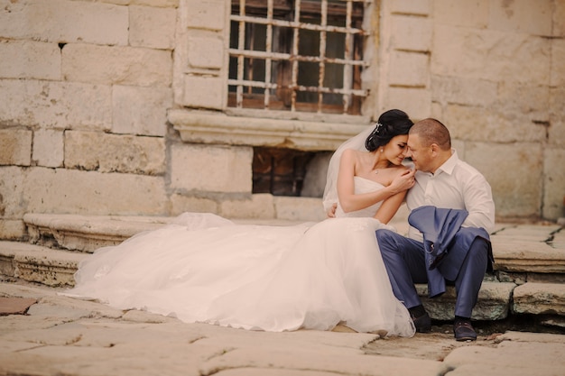 Free Photo couple sitting in a stairs