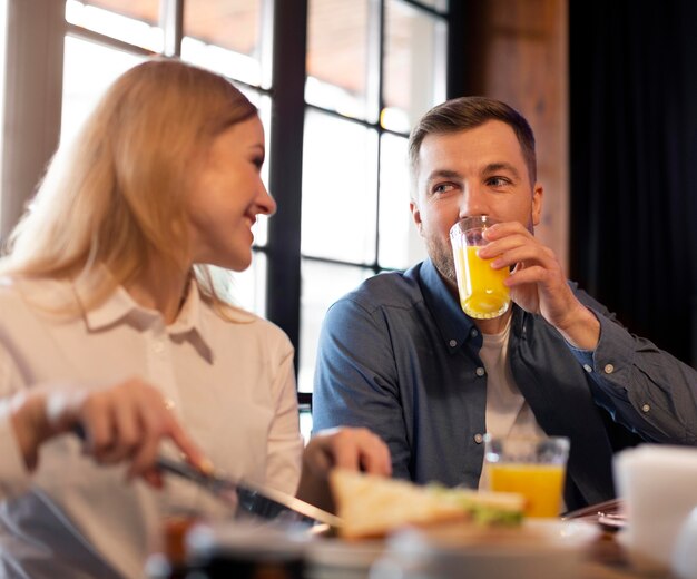 Couple sitting at table with food