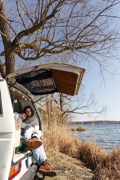 Free photo couple sitting in van full shot