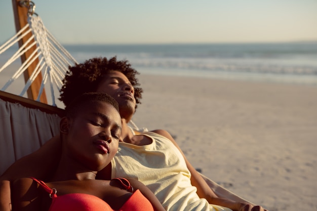 Couple sleeping in a hammock on the beach