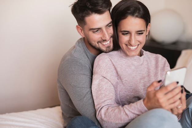 Couple smiling at phone