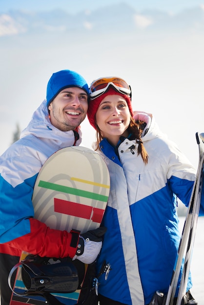 Free photo couple of snowboarders in the mountains