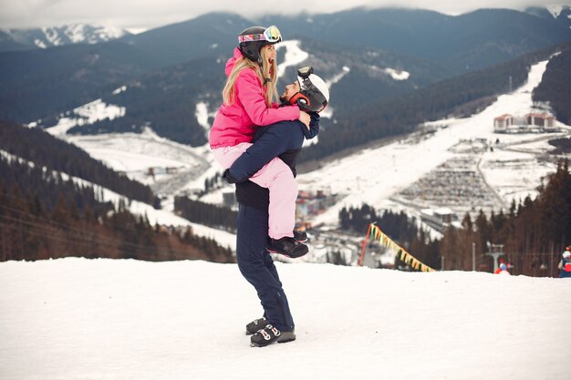 Couple in sport clothes. People spending winter vacation on mountains