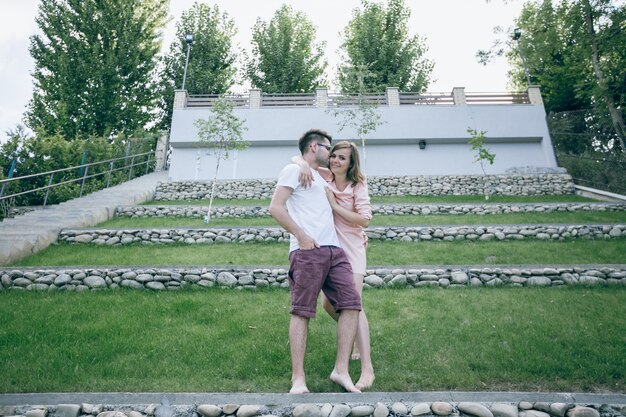 Couple standing embracing in a garden