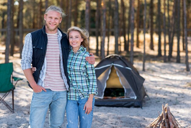 Couple standing in front of tent