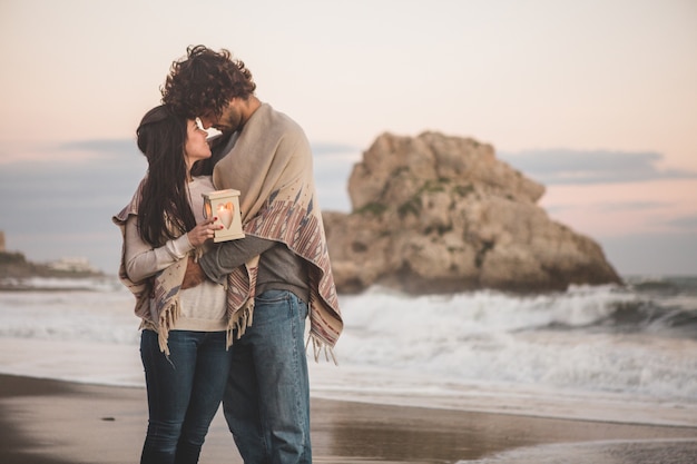 Free photo couple standing front with holding a candle