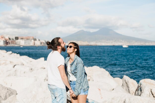 Couple and summer concept on rocks by the sea