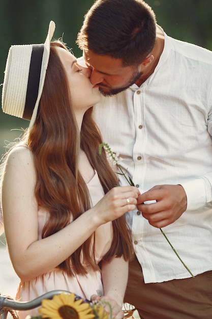 Free photo couple in a summer park. people with vintage bicycle. girl in a hat.