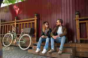 Free photo couple in synthetic leather jackets spending time together outdoors