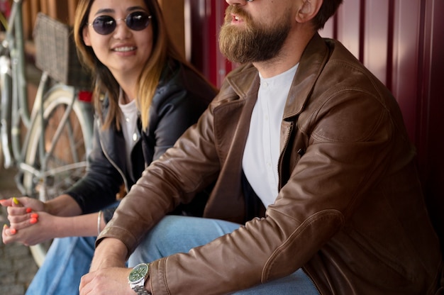 Free photo couple in synthetic leather jackets spending time together outdoors