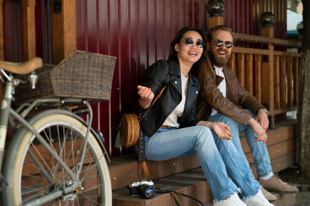 Couple in synthetic leather jackets spending time together outdoors