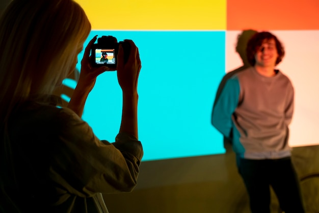 Couple taking photos in the light of movie projector