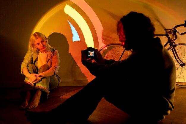 Couple taking photos in the light of movie projector