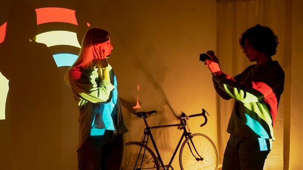 Couple taking photos in the light of movie projector