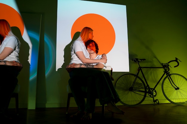 Couple taking photos in the light of movie projector