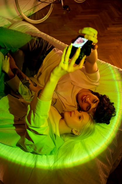 Couple taking photos in the light of movie projector