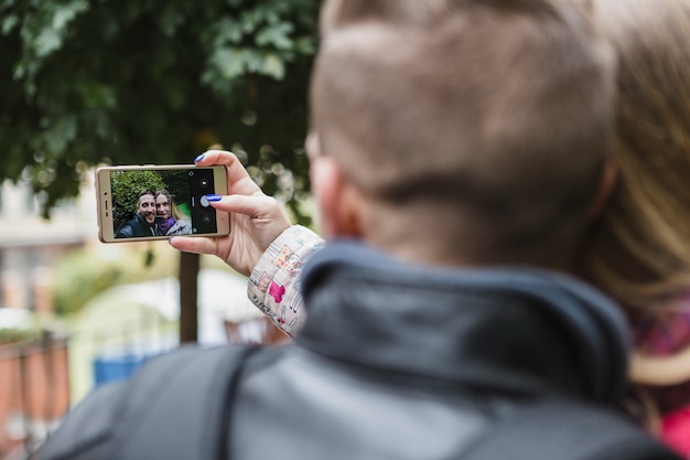 Free photo couple taking selfie in park