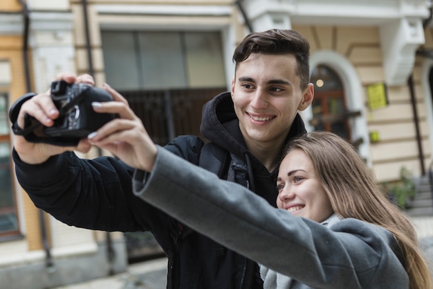 Free photo couple taking selfie on street