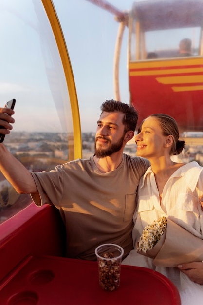 Couple taking selfie while out together at the ferris wheel