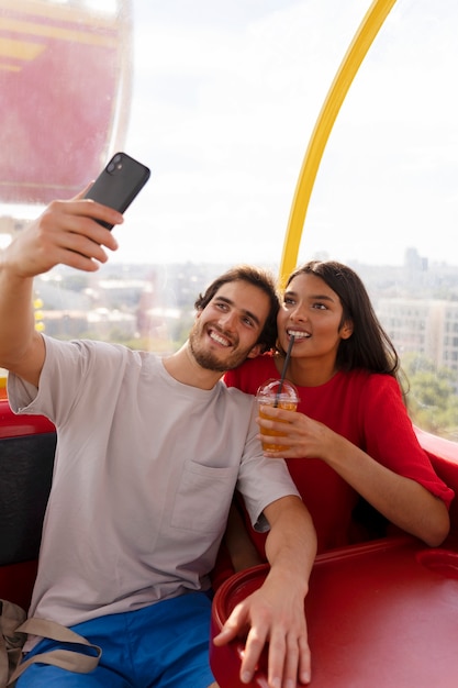 Couple taking selfie while out together at the ferris wheel