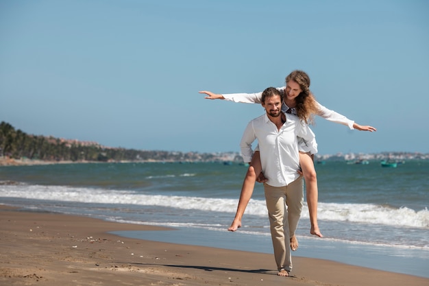 Couple taking a walk on the beach during vacation