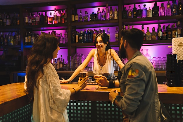 Couple talking to bartender