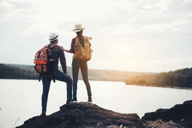 Couple Of Tourists With Backpacks on mountain