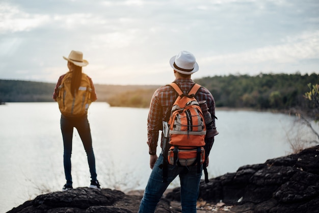 Free Photo couple of tourists with backpacks on mountain