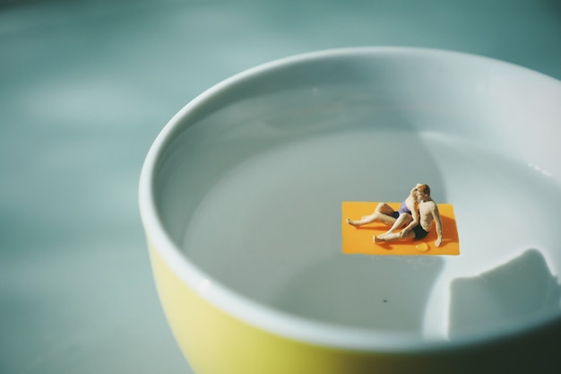 Free photo couple in a towel over water from a cup of coffee