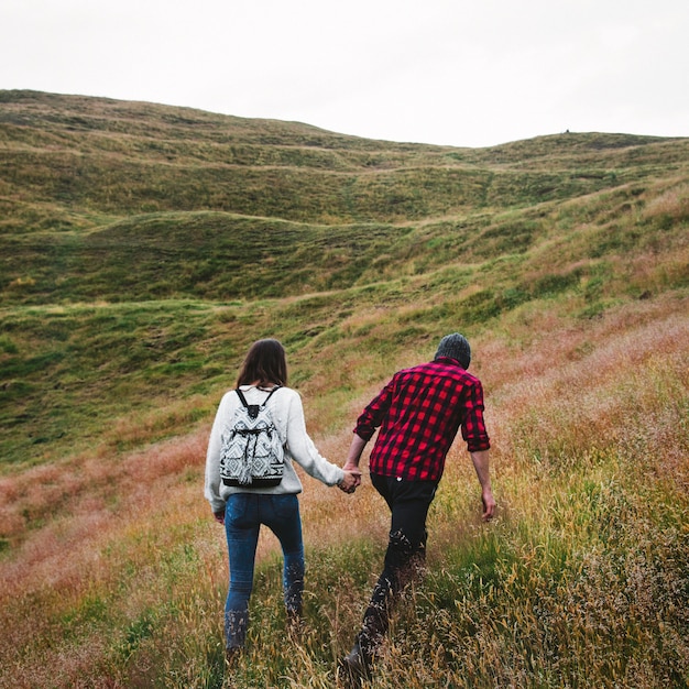 Free photo couple trekking the hills together