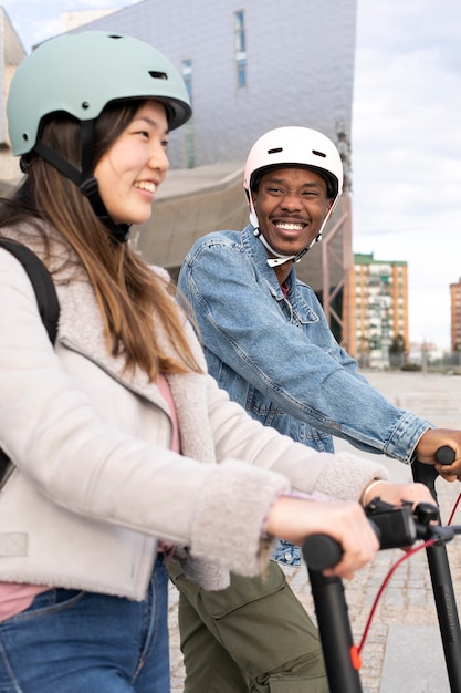 Couple using electric scooter for transportation