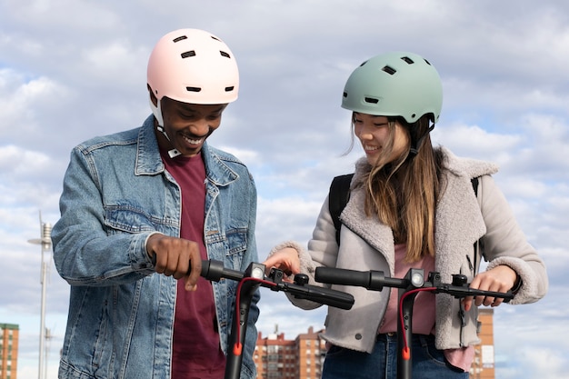 Free Photo couple using electric scooter for transportation