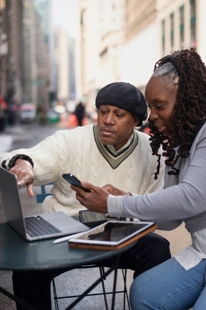 Couple using technology while traveling in the city