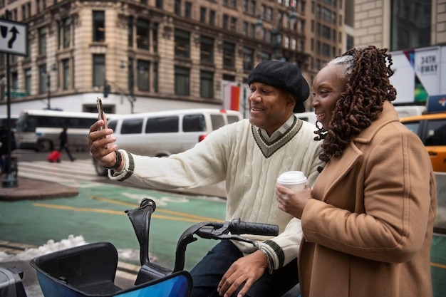 Couple using technology while traveling in the city