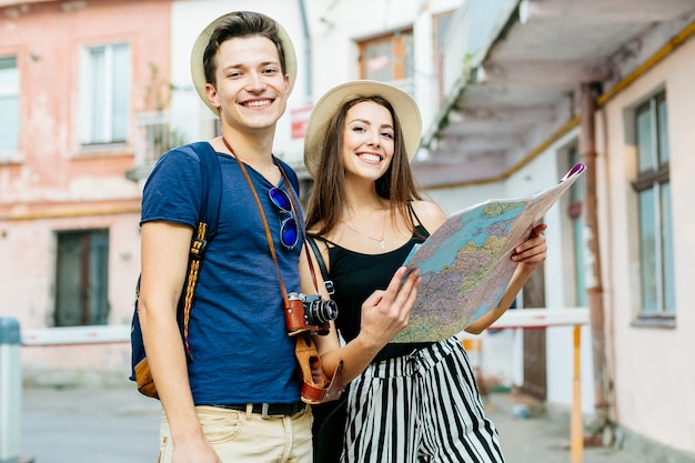 Couple on vacation in city with map