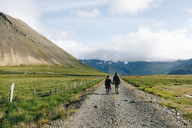 Couple walk on rural country gravel road