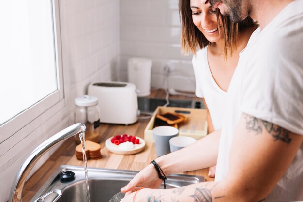 Couple washing dishes together