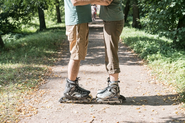 Free photo couple wearing roller skates hugging