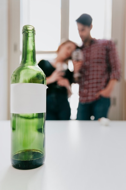 Free photo couple at window looking at bottle