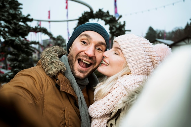 Free photo couple in winter giving a kiss