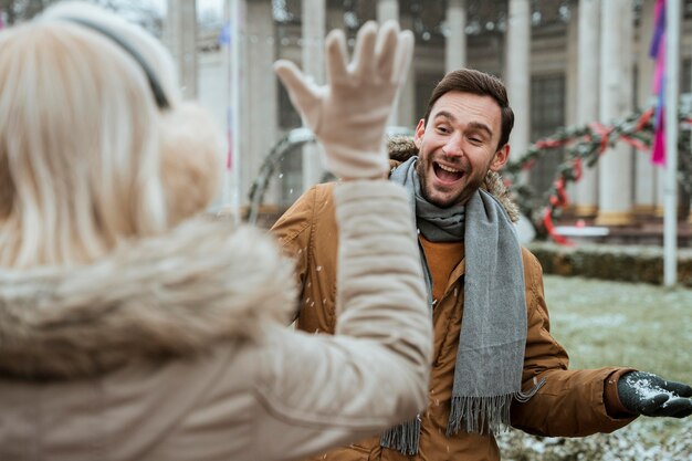 Couple in winter playing with snow