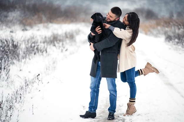 Couple in winter in the street with dog