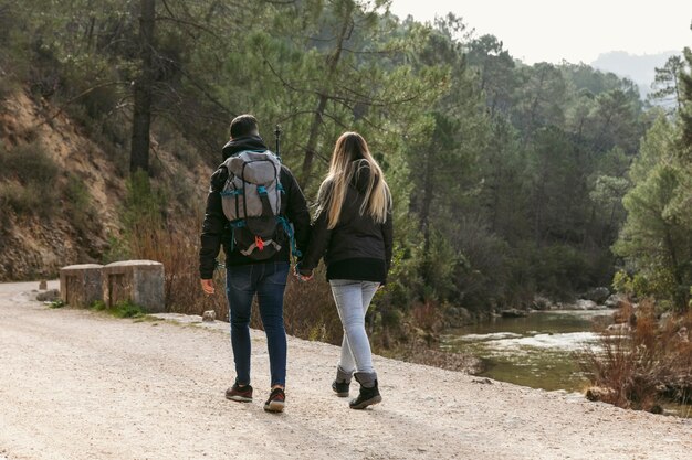 Couple with backpack exploring nature