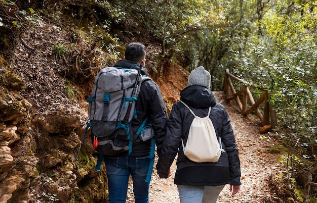 Couple with backpacks in nature close up