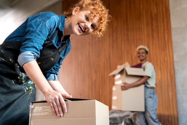 Free Photo couple with cardboard boxes in their new home