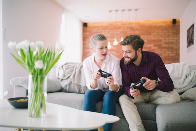 Couple with controllers at home