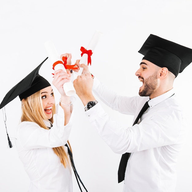 Free photo couple with diplomas having fun